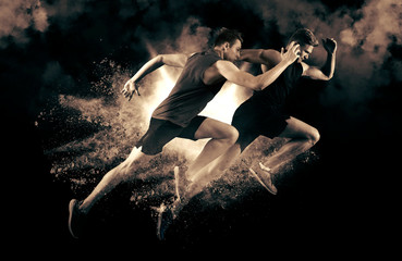 Athletic men sprinter running on smoke background