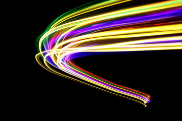 Long exposure photograph of neon multi colour in an abstract swirl, parallel lines pattern against...