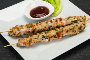 Minced pork skewer kebab with sauce