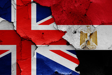 flags of UK and Egypt painted on cracked wall
