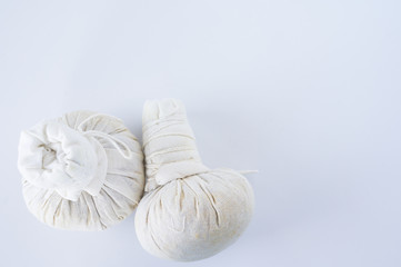 Two spa herbal compress balls on white background.Spa treatment equipment concept.