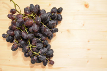 Black Grapes on Wooden Table