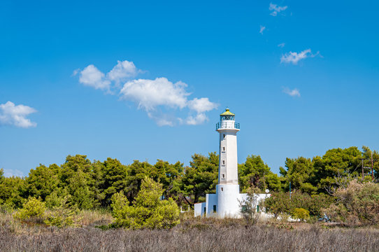 Halkidiki, Greece - September 01,2019: Possidi lighthouse. Near Possidi cape (Miti beach) there is an old lighthouse, built in 1864. &Iota;ts height is 14,5 meters and the height of its light is 23 meters.