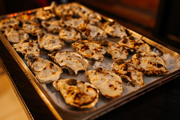 Baked mussels on a tray closeup