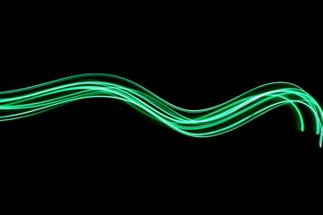 Long exposure photograph of neon green colour in an abstract swirl, parallel lines pattern against...