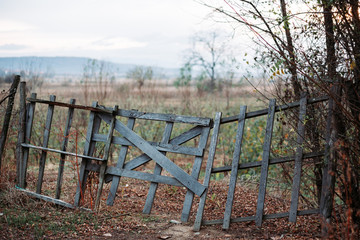 Old wooden gate, fence. Countryside in Eastern Europe