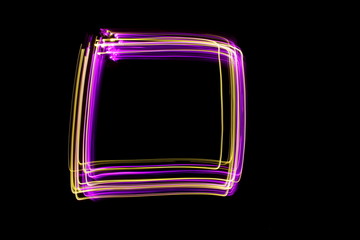 Long exposure photograph of a box square outline shape in neon colour in an abstract swirl,...