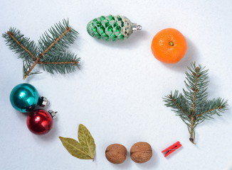 christmas new year grey background with old balls glass green cone and fir branches of spruce walnuts laurel leaves tangerines and red pin
