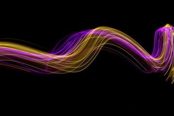 Long exposure photograph of neon colour in an abstract swirl, parallel lines pattern against a...