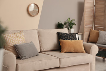 Modern comfortable sofa with pillows indoors. Stylish room interior