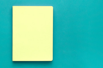 Notebook on green background. Business concept. Top view, flat lay, copy space.