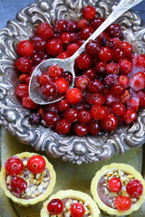 Cupcakes with cranberries and hazelnuts on a black background