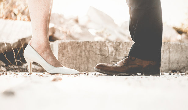 Man and Woman in Fancy Shoes Facing One Another