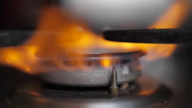 igniting the restaurant stove flame slow motion