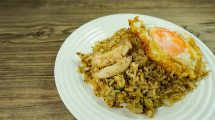 Thai cuisine ,fried rice with crab on wood table background.           