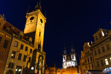 Fototapeta na wymiar Prague Old Town Square (Stare Mesto) historical city centre. Astronomical Clock (Orloj) and Tower of City Hall building, Gothic Church of Our Lady before Tyn, night view, Bohemia, Czech Republic