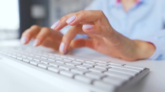 Female hands typing on a computer keyboard. Concept of remote work.