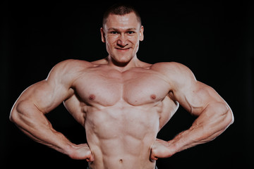 Fototapeta premium Sport the athlete bodybuilder shows off his muscles