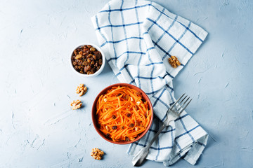Carrot walnut raisin salad with glass of water