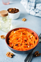 Carrot walnut raisin salad with glass of water