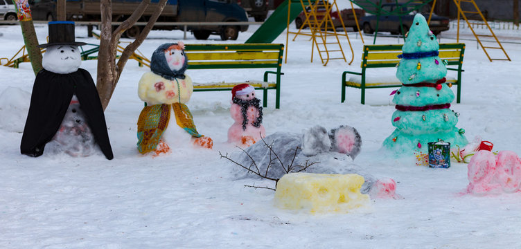 Snow figures in front of the house in Russia. 2020, the year of the rat