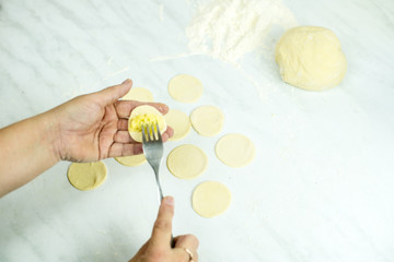 We cook the filling, knead the dough, sculpt the dumplings. Selective focus.