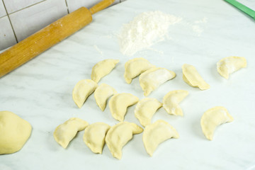 We cook the filling, knead the dough, sculpt the dumplings. Selective focus.