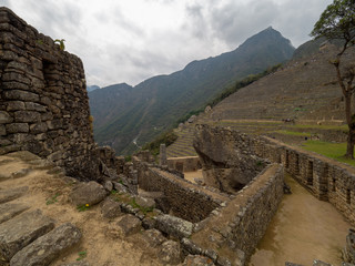 Fototapeta na wymiar Temple of the condor at Machu Picchu, terraces and mountains on the background