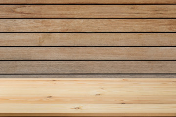 Fototapeta premium Wooden board in front of a blurred background. Perspective brown wood with a blurry background of nature or park - can be used to showcase or assemble your products. Mock up to display the product.