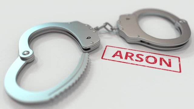 ARSON stamp and handcuffs. Crime and punishment related conceptual 3D animation