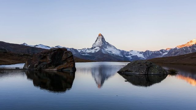 Timelapse of sunrise at Stellisee lake and Matterhorn peak. Swiss Alps, Zermatt, Switzerland.
