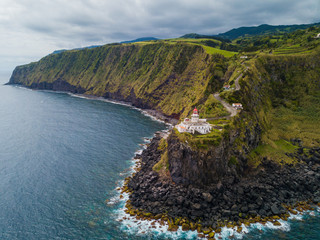 Lighthouse at the cliffs aerial on Santa Maria Azores Miradouro da Ponta do Arnel