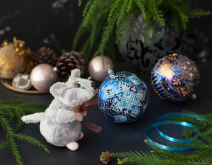 New Year composition. Rat is a symbol of year 2020, soft toy and festive baubles. Chinese zodiac