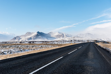 Droga w zimowym krajobrazie, w tle góry