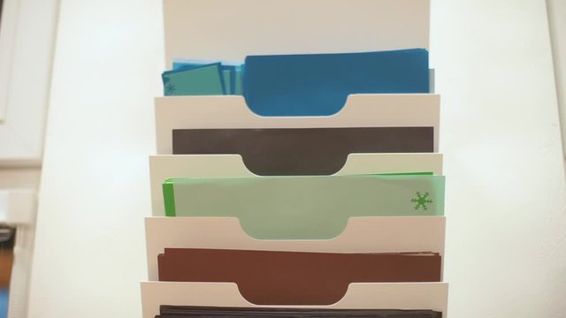 Rack with folders on the wall in the office.
