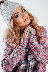 the girl in the hat and sweater posing