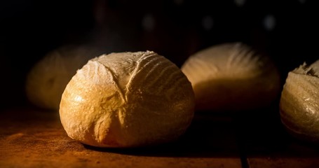 Warm fresh ciabatta in a bakery. Making bread and eco production. Manufacturing process working hard. Bakery shop and selling rooty. Baking Italian bio bread in oven. Time lapse footage of cooking.