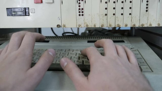Man Typing On An Old Computer Keyboard