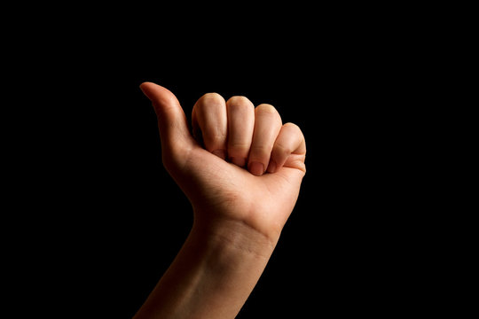 Hand Showing Sign of A Alphabet in American Sign Language (ASL), isolated on black background. Sign language