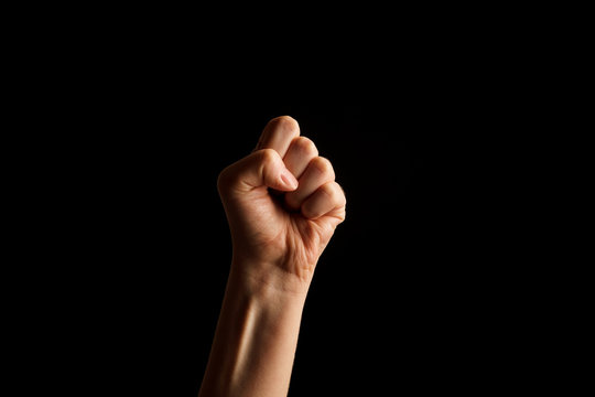 Hand Showing Sign of S Alphabet in American Sign Language (ASL), isolated on black background. Sign language