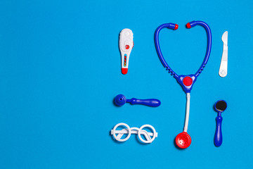 Top view of toys medical set on light blue background