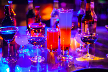 Selection of best selling cocktails in bar blurred background, Cocktails on bar counter alcohol collection bartender liqueur