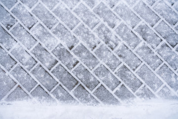 Texture of snowy paving slabs