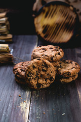 Chocolate cookies on wooden table. Chocolate chip cookies shot on black