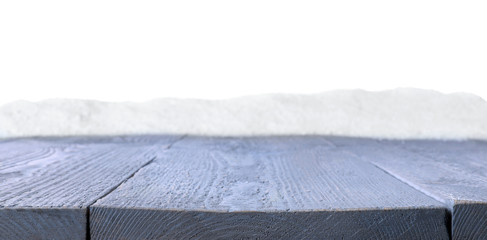 Heap of snow on grey wooden surface against white background