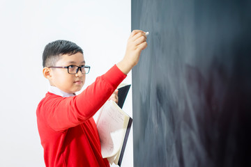 Side view of an Asian boy solving a calculation