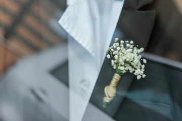 wedding boutonniere on suit of groom
