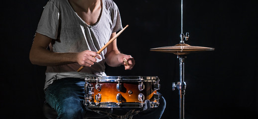 The drummer plays the drums. The process of playing a musical instrument. The concept of music.