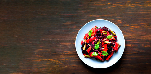 Baked vegetables in blue plate on wooden background. Asian food concept. Budget-friendly menu.Close-up