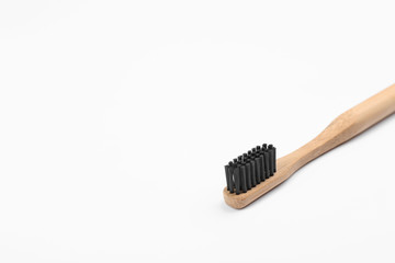 Bamboo toothbrush with charcoal bristle isolated on white